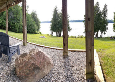 Zen garden with Muskoka chairs and hammock overlooking lake