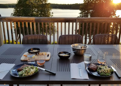 Enjoy meals together inside or out on the deck with 8 person dining tables